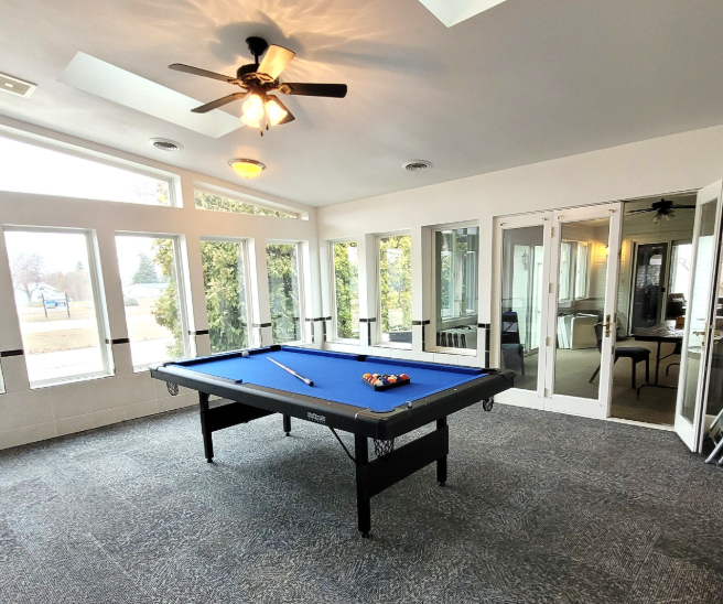 airy clubhouse game room with pool table at brooke view in boise id