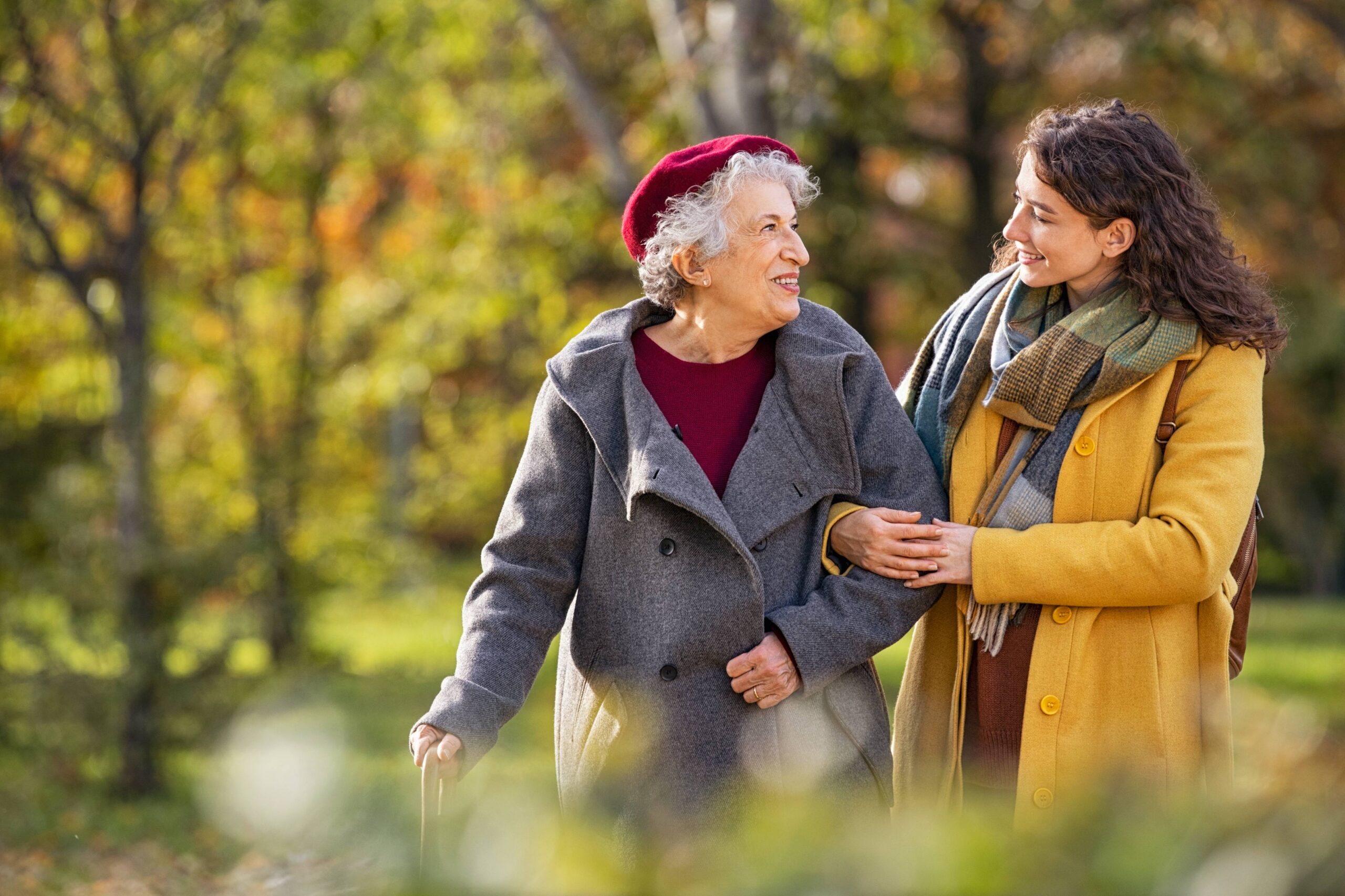 elderly woman walking with companion scaled