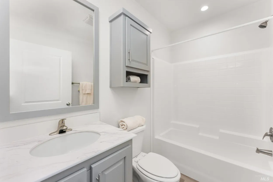 elegant bathroom with grey cabinetry and subway tile at brooke view in boise id