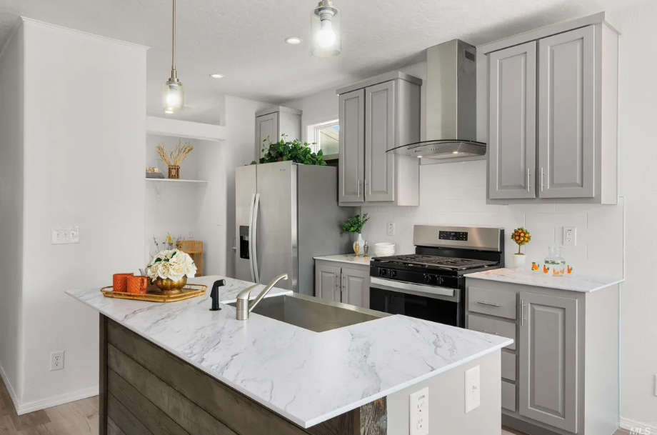 refined kitchen with oversized island and grey cabinets at brooke view in boise id